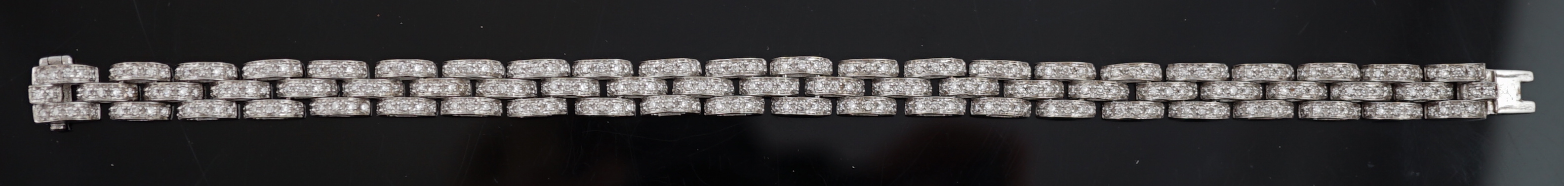 An 18k white gold and diamond chip set triple row bracelet